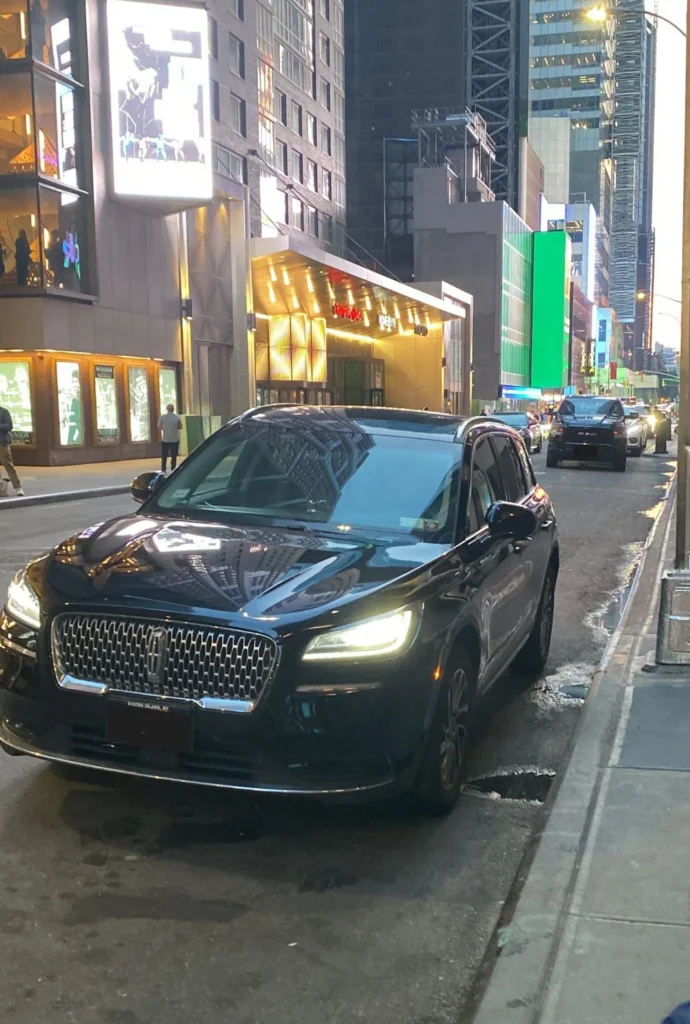 Black sedan parked near sidewalk
