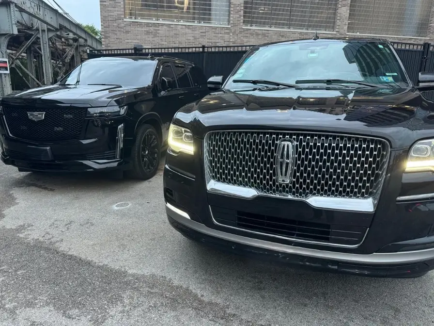 2 Black SUVs side to side