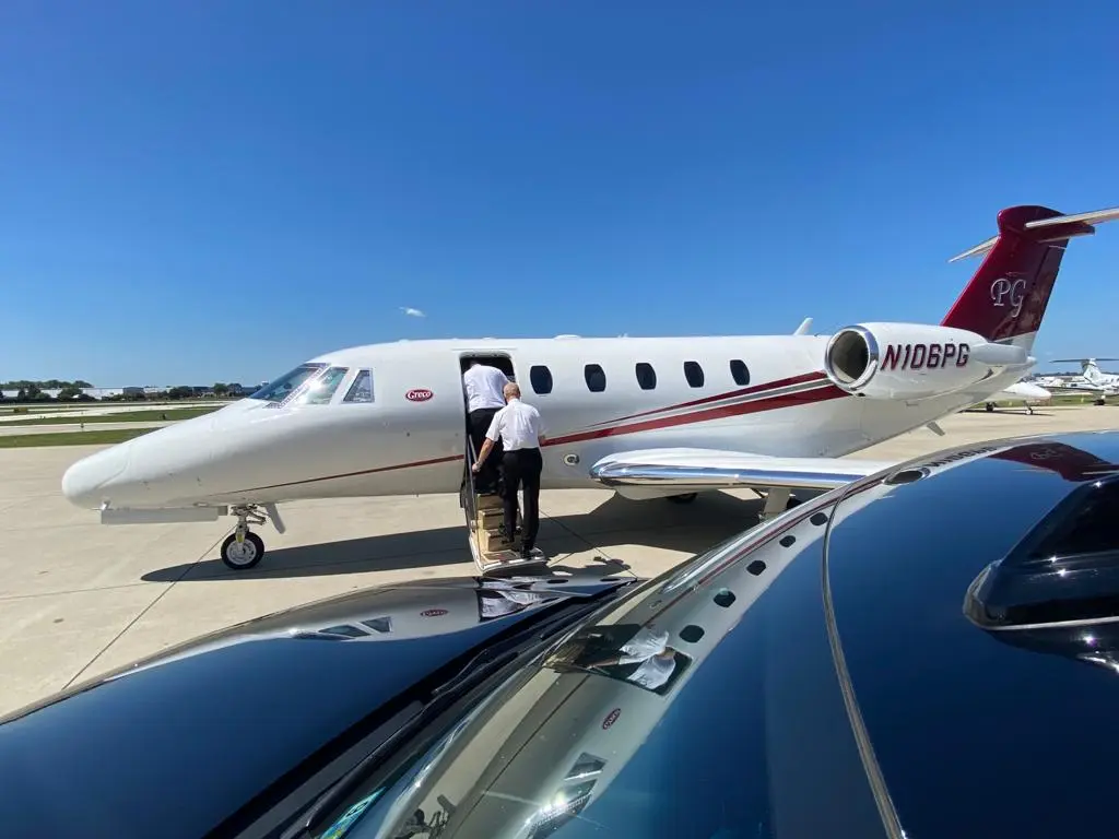 SUV parked near Private Jet